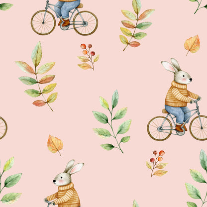 Vintage-inspired pale pink childrens wallpaper featuring cute, adorable bunnies riding old-fashioned bikes